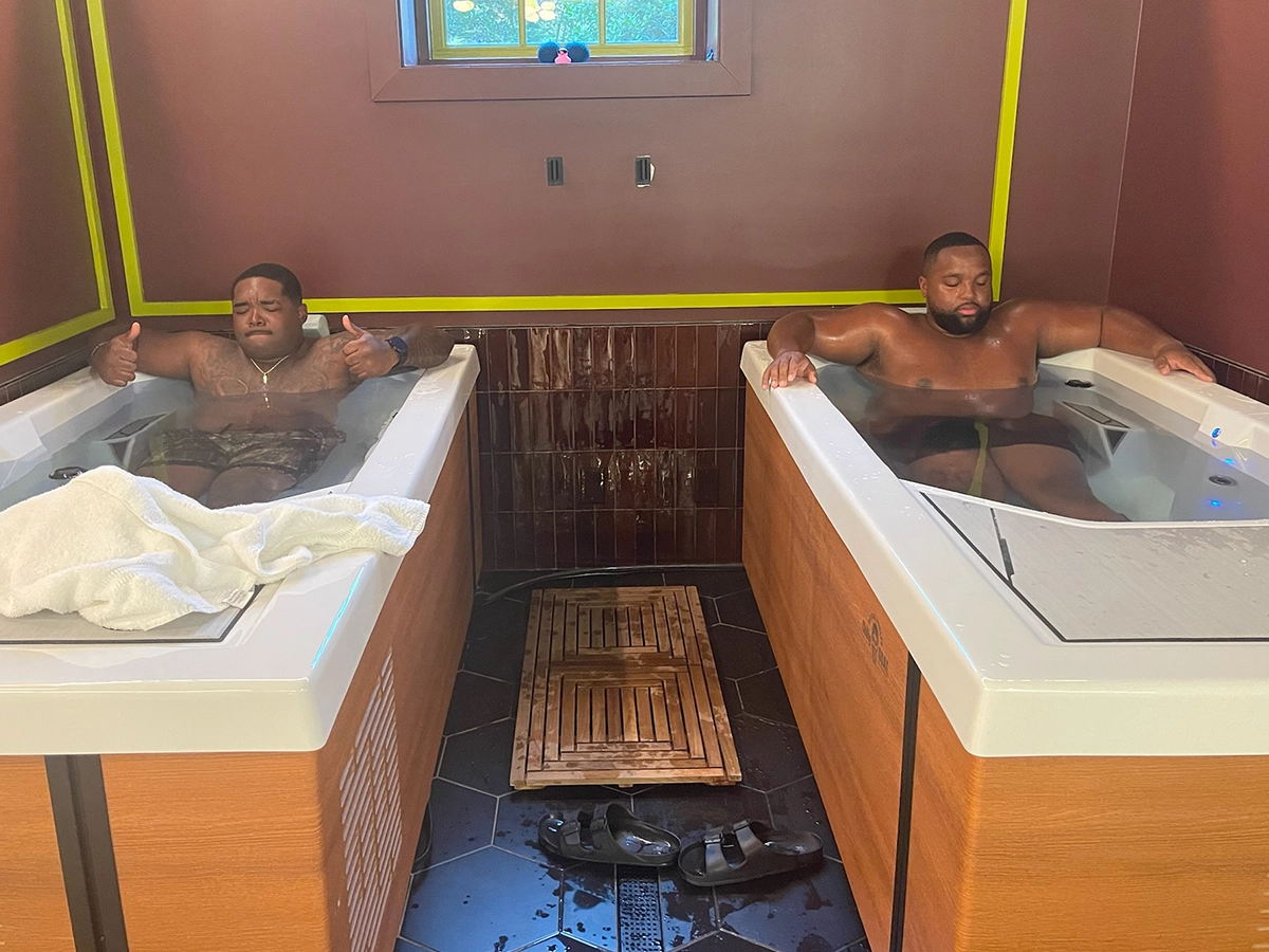 Two men giving a thumbs up from the side-by-side cold plunge tubs at R3 Contrast